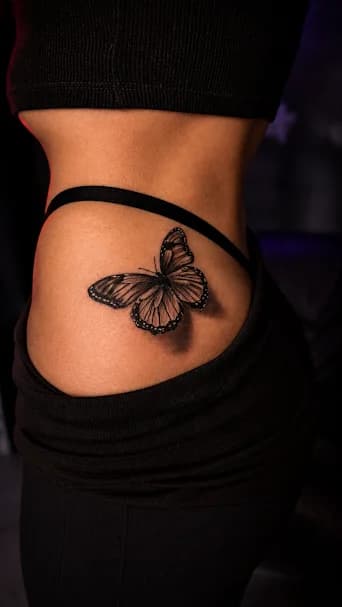 Butterfly — A beautiful, realistic butterfly on a woman's hip.