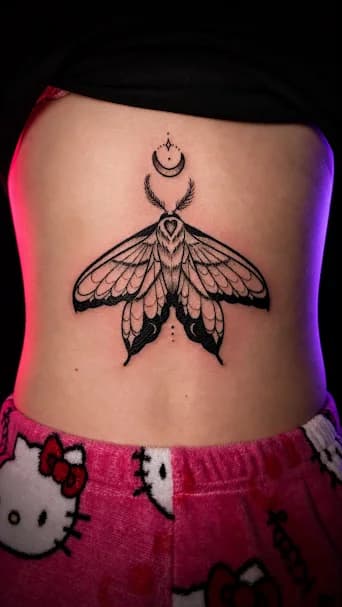 Moth on the Back — A huge moth on a woman's lower back