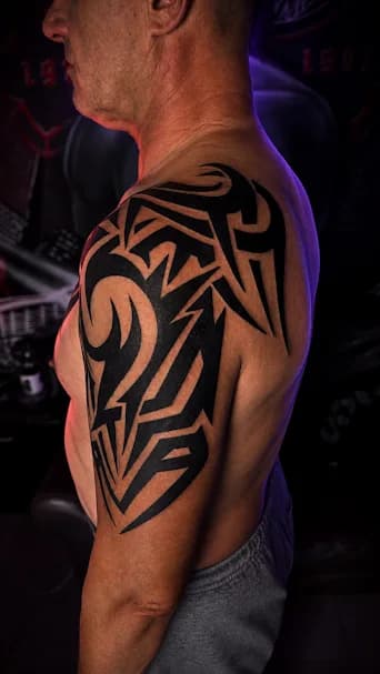Tribal — Bold fill-work on a man's shoulder